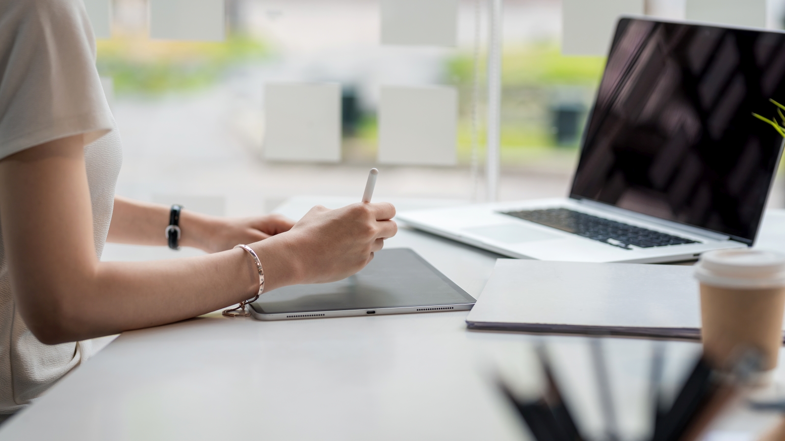 Close up of a businesswoman working on a tablet at the office.